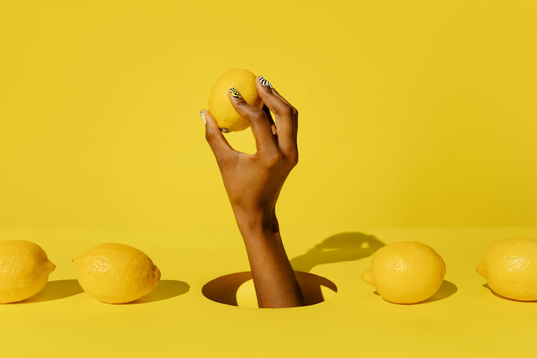 A yellow silicone vibrator surrounded by peeled bananas on a bright yellow background
