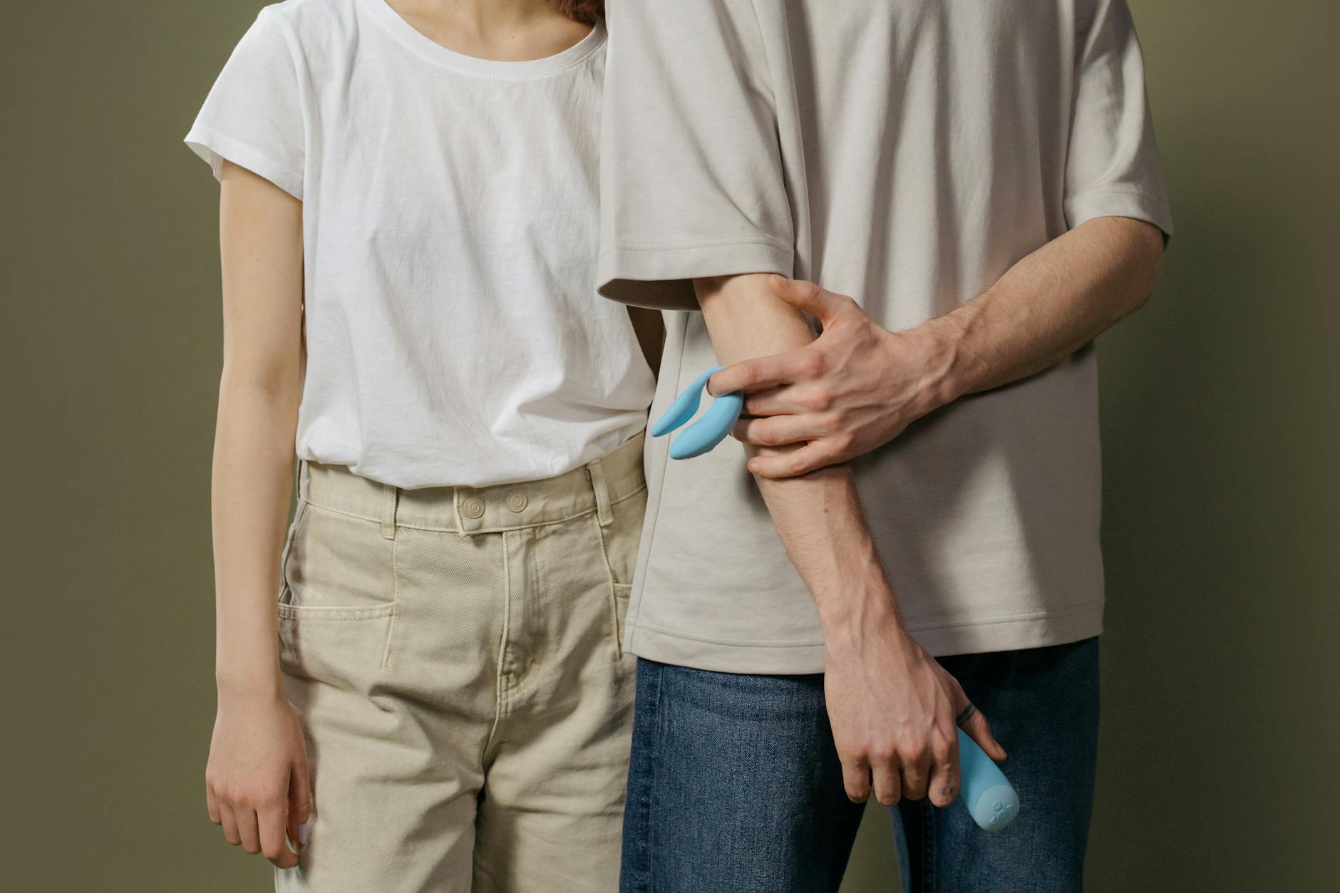 A young couple standing together indoors, discussing modern intimacy and pleasure.